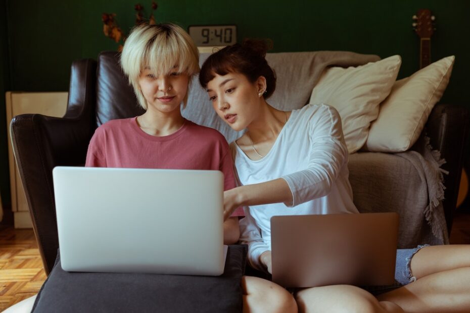 Two women using laptops